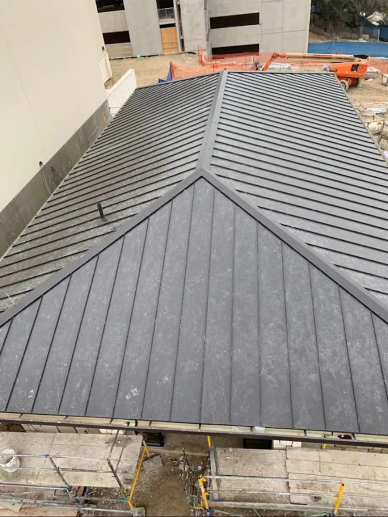 Commercial metal roof construction with crane equipment in North Cornwall